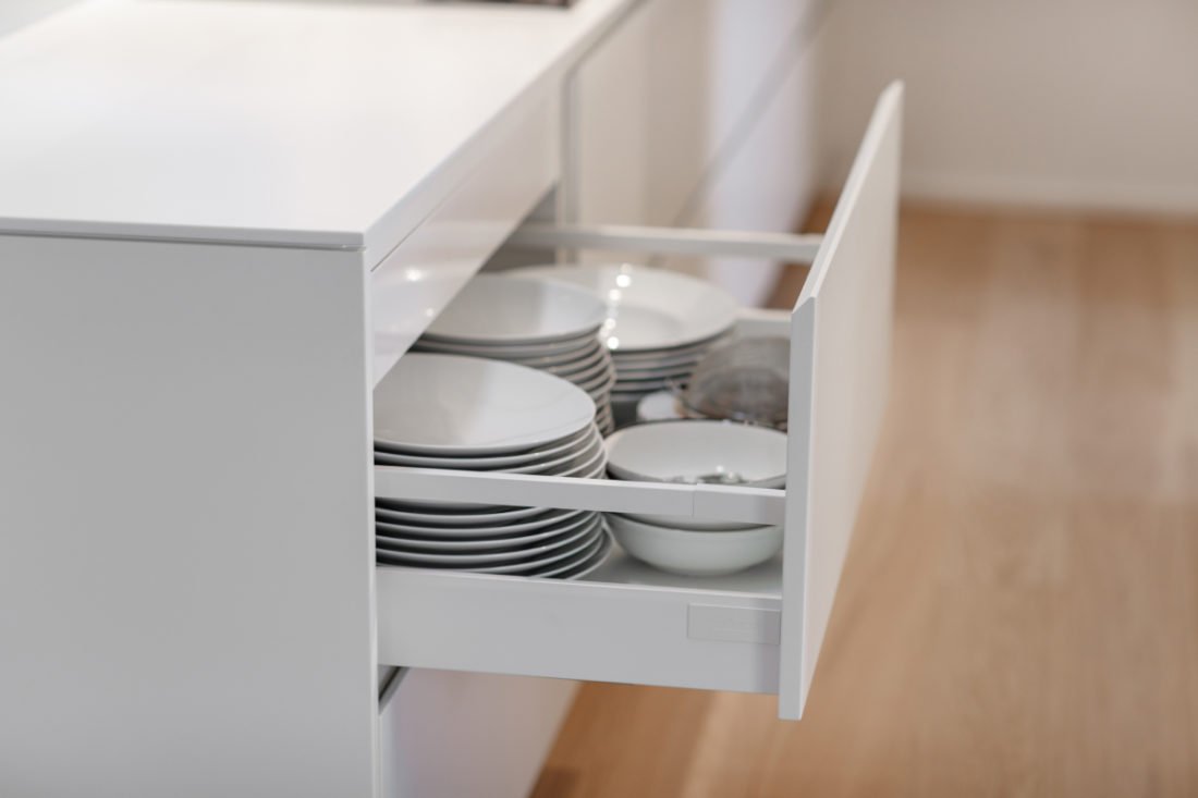 Individuelle Stauraumkonzepte für jede Nische
Gerade in städtischen Wohnlagen in Stuttgart ist Platz oft ein kostbares Gut. Standardisierte Küchenschränke mit festen Breitenrastern verschenken hier oft wertvollen Stauraum durch breite Passleisten oder ungenutzte Ecken. Bei unserer Maßfertigung gibt es keine toten Winkel. Wir fertigen Schränke, die exakt in die vorhandene Nische passen, sei sie auch noch so schmal. Wir nutzen die volle Raumhöhe bis unter die Decke, bauen passgenaue Lösungen um Versorgungsschächte herum oder integrieren Stauraum unter Dachschrägen und Treppen. Doch nicht nur das Außenmaß ist entscheidend, sondern auch das Innenleben. Wir statten Ihre Schränke mit intelligenten Ordnungssystemen aus, die genau auf Ihren Bedarf zugeschnitten sind. Ob Apothekerschränke für Vorräte, spezielle Einsätze für Gewürze und Messer, Le-Mans-Auszüge für Eckschränke oder integrierte Mülltrennsysteme – alles hat seinen festen Platz. Wir analysieren gemeinsam mit Ihnen, was Sie unterbringen müssen, und planen den Stauraum so effizient, dass Ihre Küche stets aufgeräumt wirkt und Sie nie lange nach dem richtigen Utensil suchen müssen.
